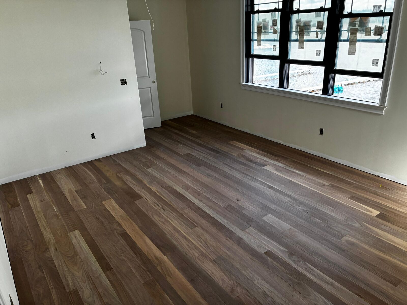 Finished residential wood flooring project with window light